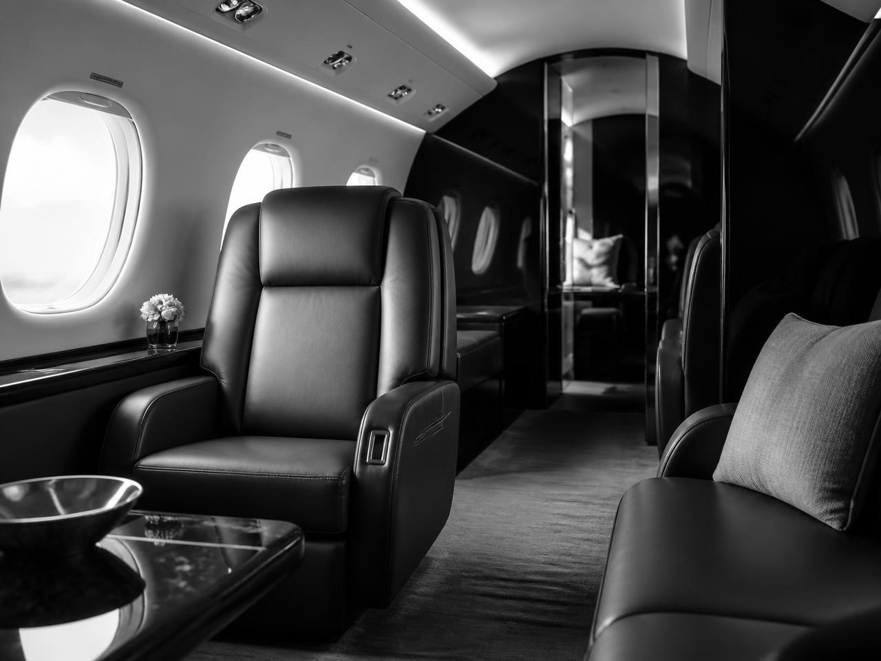 Interior of a private jet cabin with leather seating and soft window light